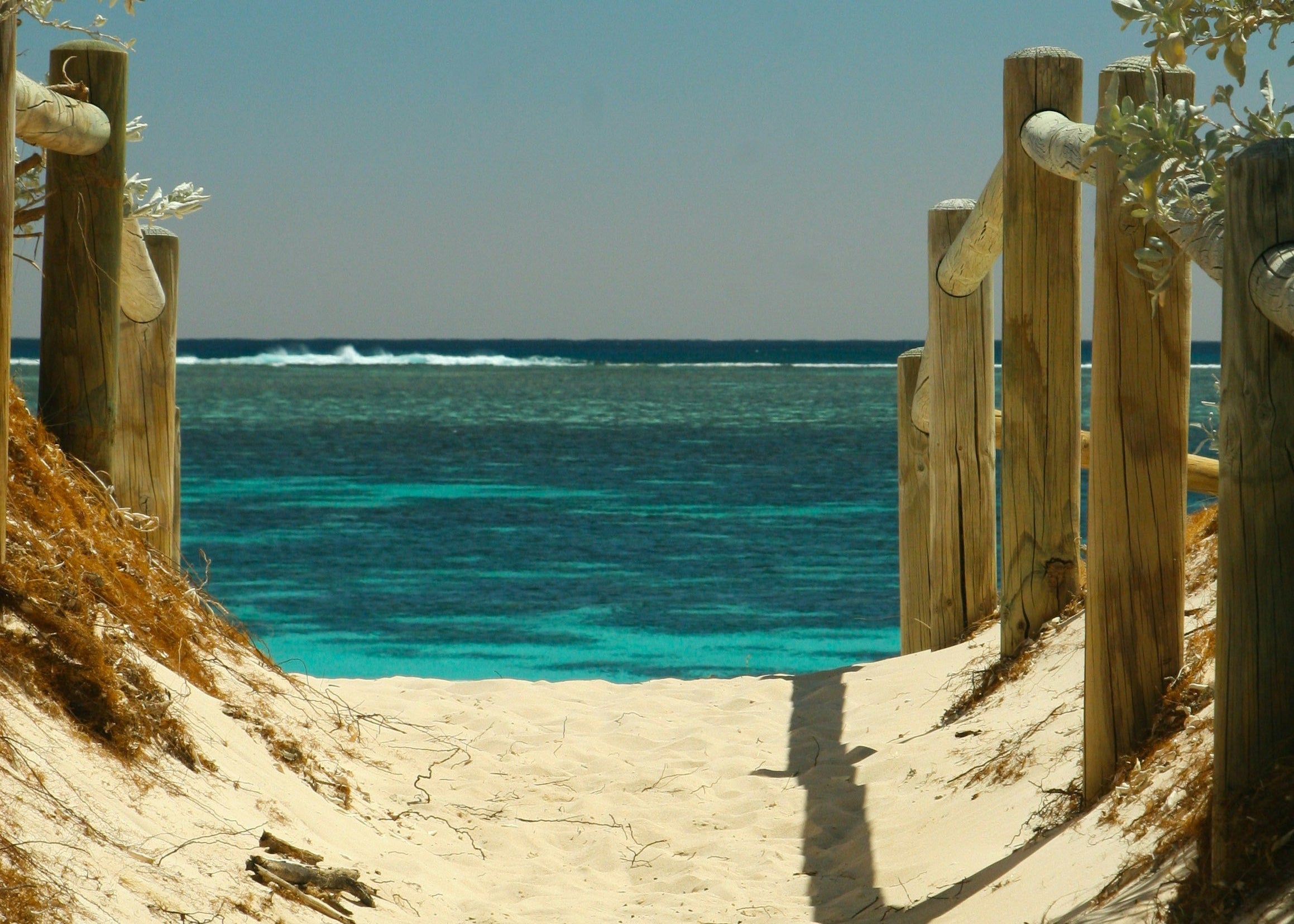 Summer collection — a sandy path leading down to turquoise sea