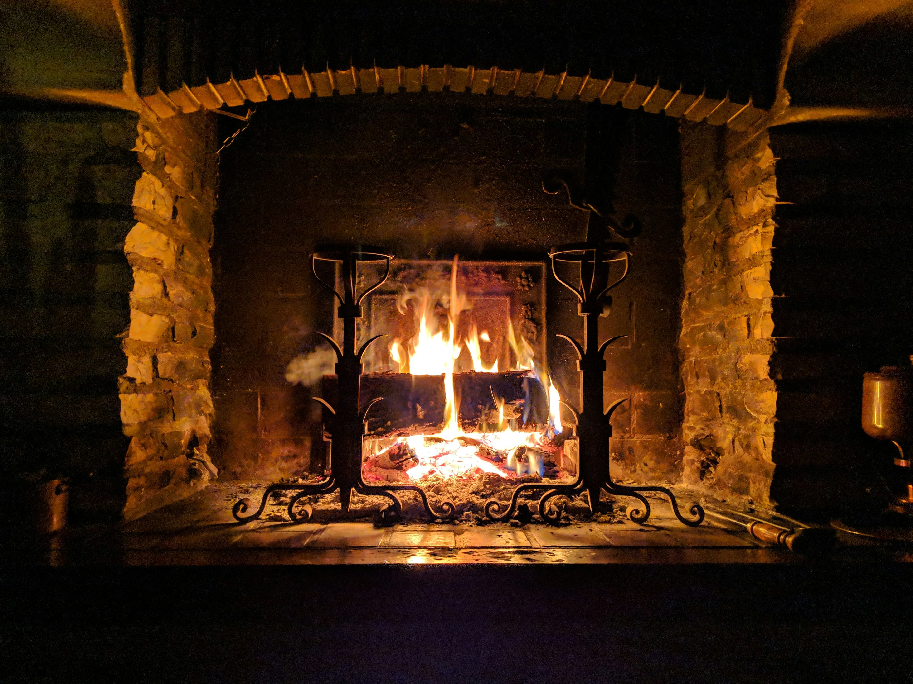 Winter collection — a warm fire burning in a stone hearth